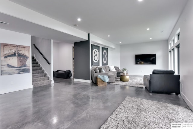 living room featuring baseboards, recessed lighting, concrete floors, and stairs