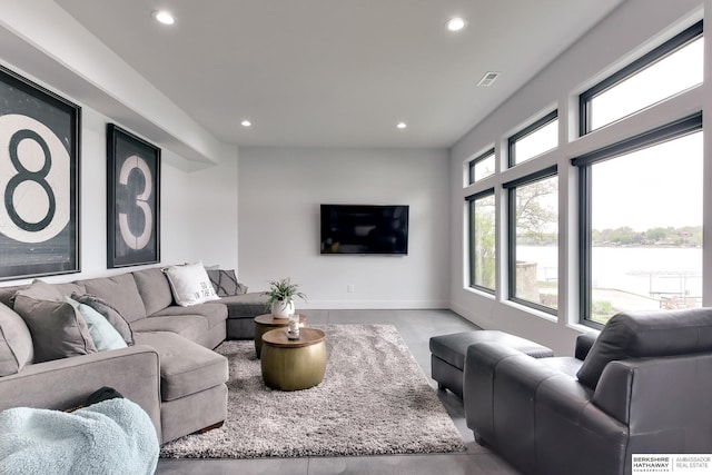 living room with recessed lighting, baseboards, visible vents, and concrete floors