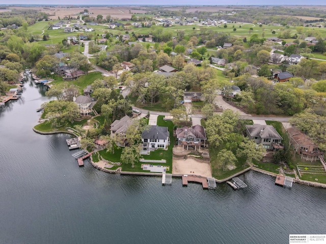 birds eye view of property with a water view and a residential view