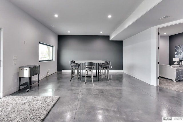 dining space with recessed lighting, baseboards, and finished concrete flooring