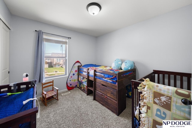 carpeted bedroom featuring baseboards