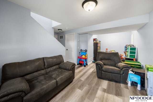 living room featuring visible vents and light wood-style flooring