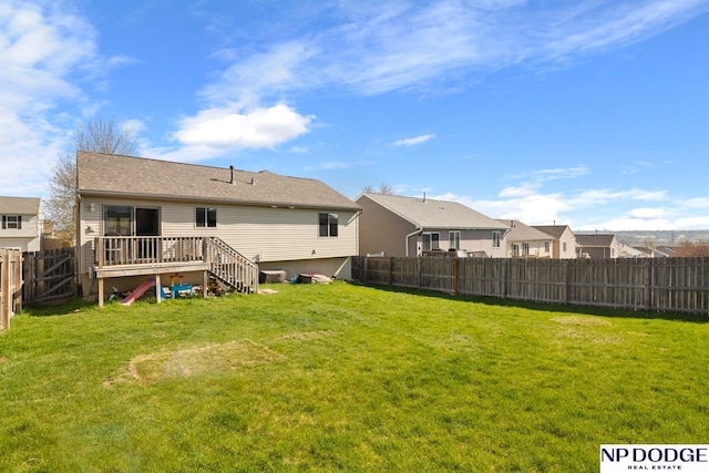 back of property with a lawn and a fenced backyard