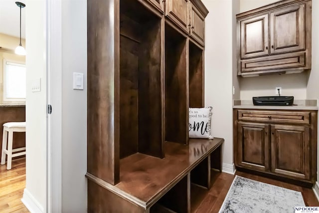 mudroom featuring baseboards and dark wood finished floors