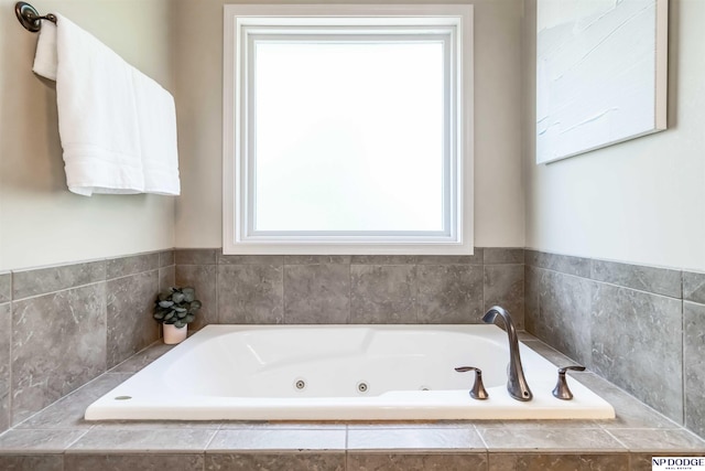 bathroom featuring a tub with jets