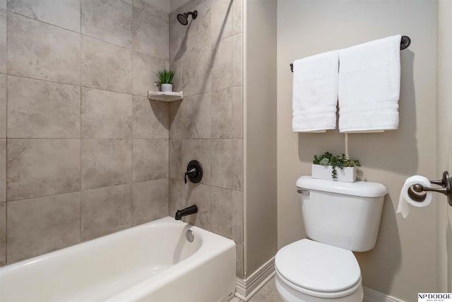 bathroom featuring baseboards, bathing tub / shower combination, and toilet