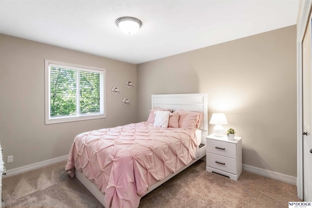 bedroom featuring carpet floors and baseboards