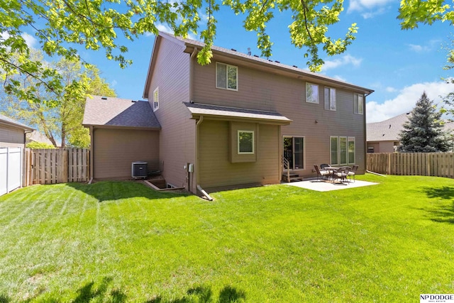 back of house featuring a lawn, a fenced backyard, cooling unit, and a patio area