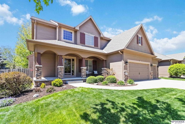 view of front facade featuring a porch, a front yard, driveway, and stone siding