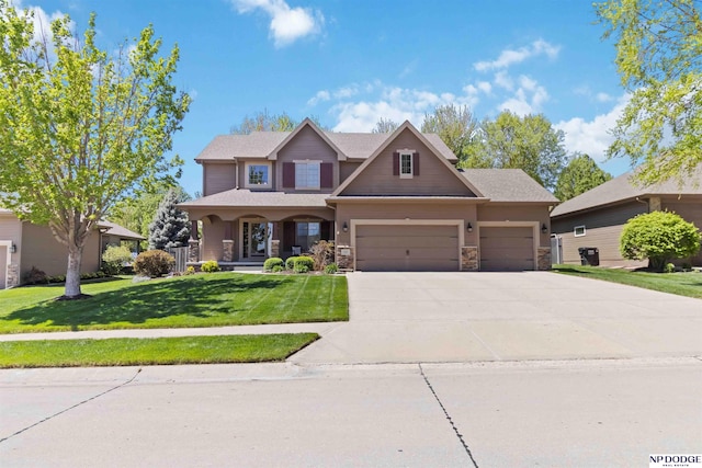 craftsman-style house featuring a porch, driveway, a front yard, a garage, and stone siding