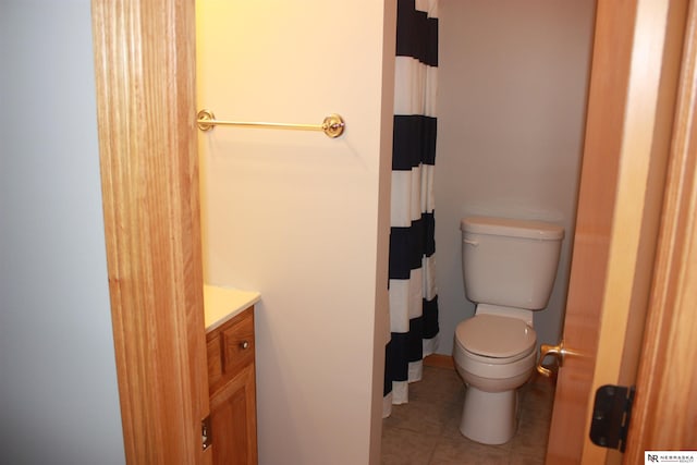 bathroom with toilet, a shower with curtain, tile patterned flooring, and vanity