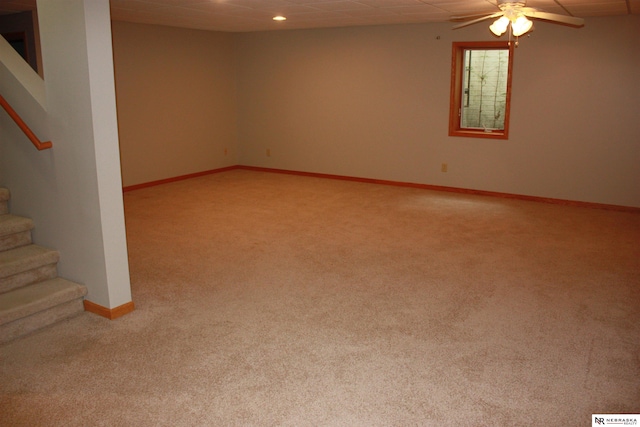 below grade area with stairway, baseboards, light carpet, and recessed lighting