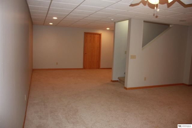 carpeted spare room with stairway, baseboards, a drop ceiling, and recessed lighting