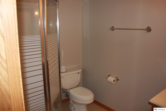 full bath featuring toilet, tile patterned flooring, and a stall shower