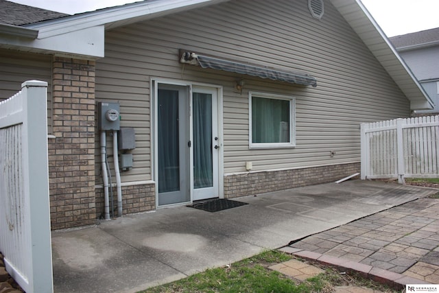 rear view of property featuring fence and a patio