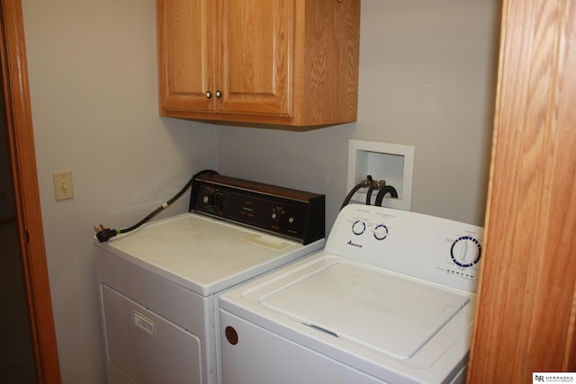 laundry room featuring washer and clothes dryer and cabinet space