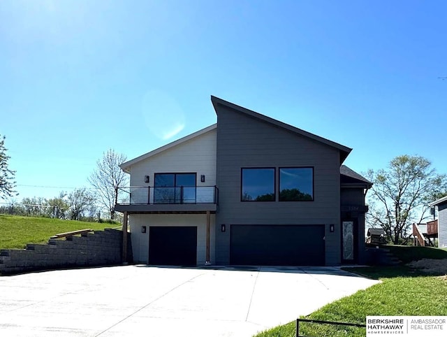 view of property exterior with a garage, a lawn, concrete driveway, and a balcony
