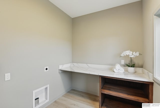 washroom featuring electric dryer hookup, laundry area, light wood-style flooring, and baseboards