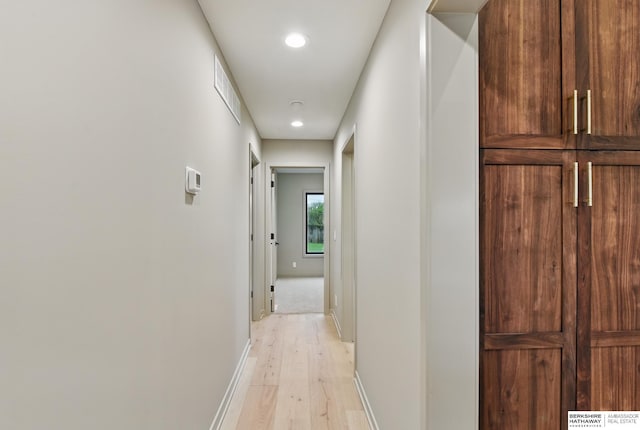 hallway featuring recessed lighting, baseboards, light wood finished floors, and visible vents