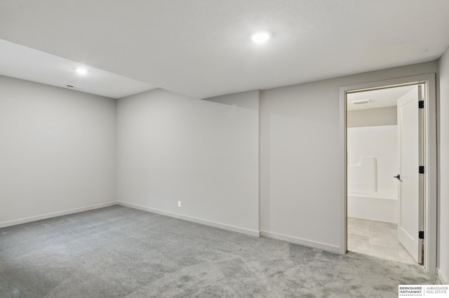 finished below grade area featuring baseboards, carpet flooring, and recessed lighting