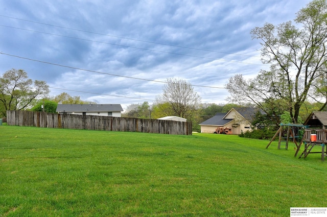 view of yard with a playground and fence