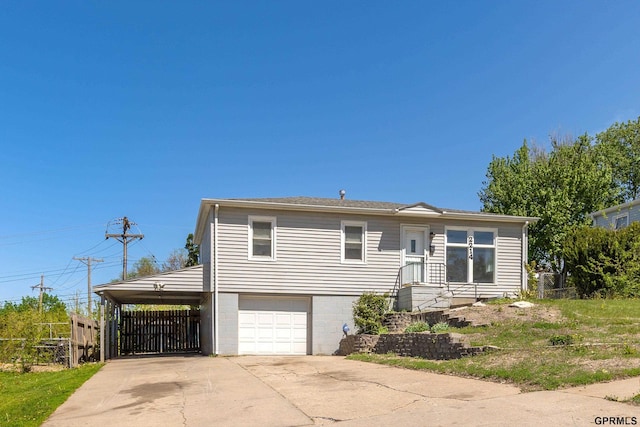 ranch-style home with fence, an attached garage, an attached carport, and driveway
