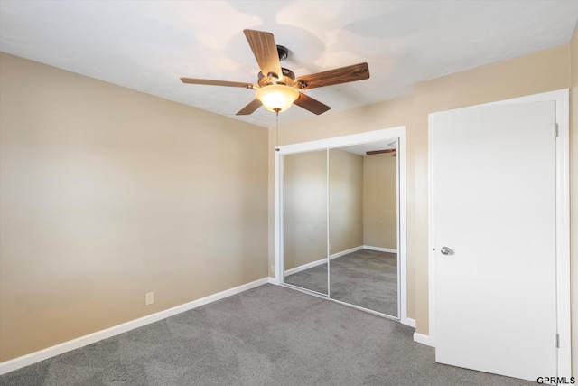 unfurnished bedroom with baseboards, a ceiling fan, carpet, and a closet