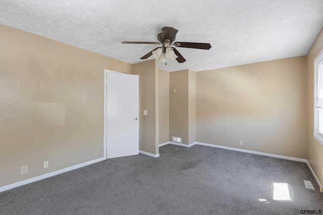 empty room featuring a textured ceiling, ceiling fan, visible vents, and dark colored carpet