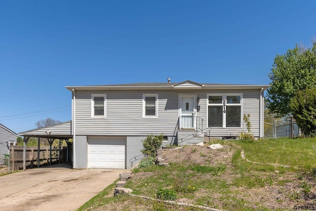 single story home with an attached garage, fence, driveway, and a carport