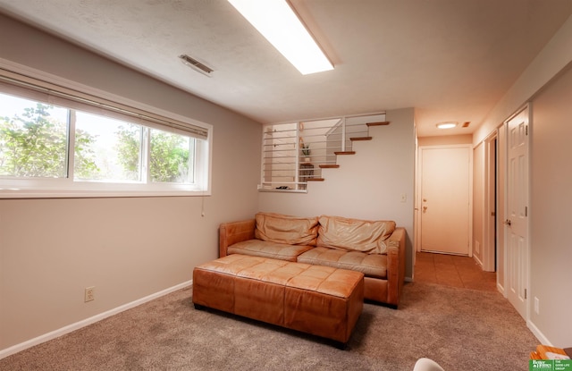 living room with carpet floors, baseboards, and visible vents