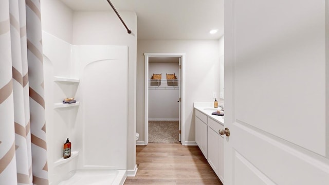 12663 S 205th St, Gretna, NE 68028 - bathroom with a walk in closet, walk in shower, wood finished floors, vanity, and recessed lighting