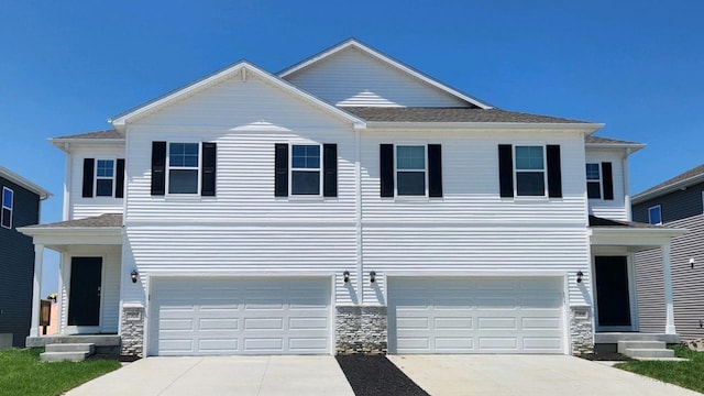 7903 N 169th St, Bennington, NE 68007 - view of front of house with a garage, driveway, and stone siding