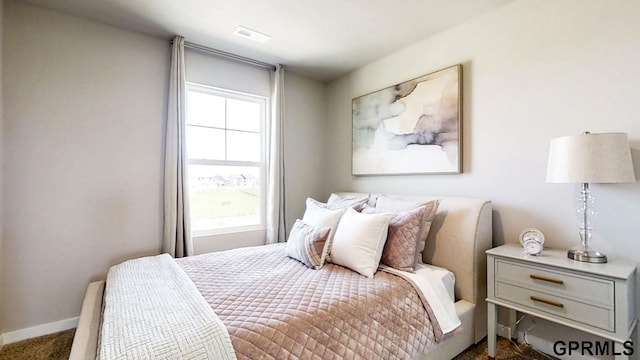 bedroom featuring carpet flooring, baseboards, and visible vents