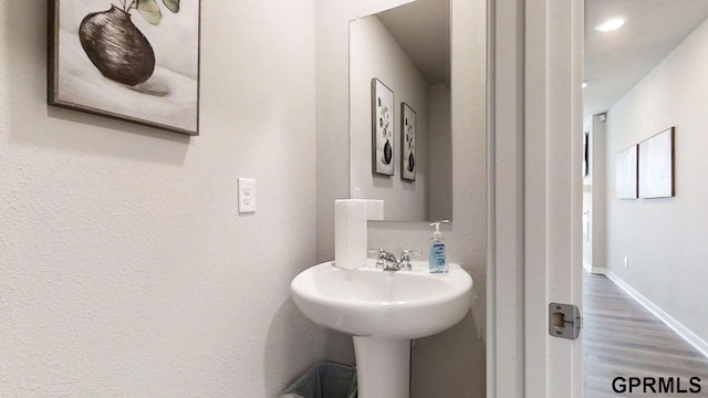 bathroom featuring baseboards and wood finished floors