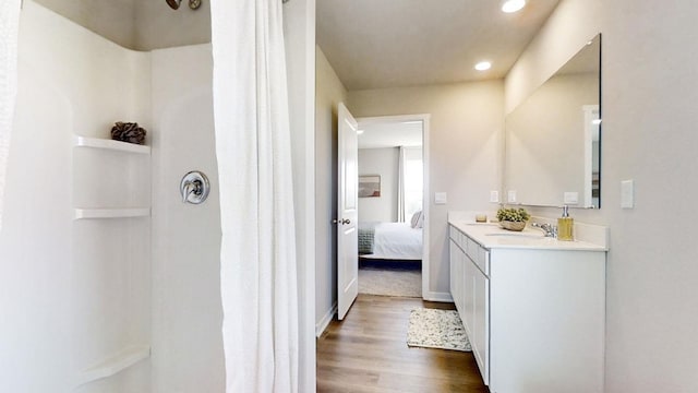 ensuite bathroom featuring recessed lighting, connected bathroom, wood finished floors, and a shower with curtain