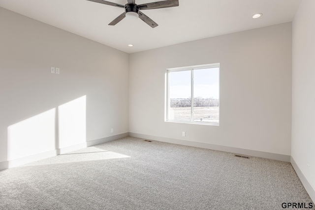 empty room with light colored carpet, a ceiling fan, baseboards, and recessed lighting