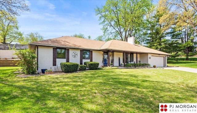 ranch-style home with covered porch, driveway, a chimney, a front yard, and a garage