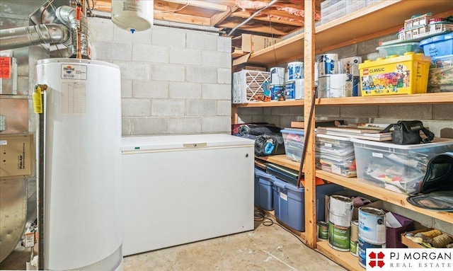 interior space featuring concrete block wall and gas water heater