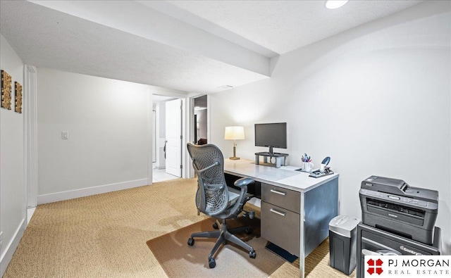 office with baseboards and light colored carpet