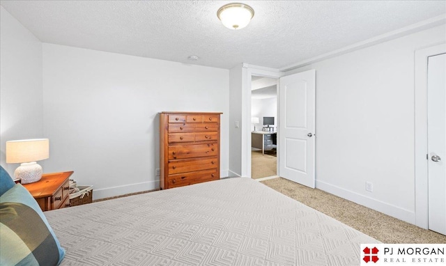 carpeted bedroom featuring baseboards and a textured ceiling
