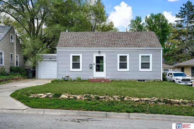 colonial-style house featuring roof with shingles, a front lawn, a garage, entry steps, and driveway
