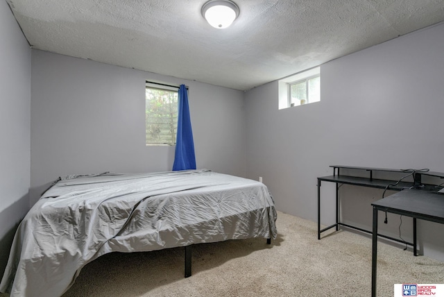 carpeted bedroom featuring a textured ceiling