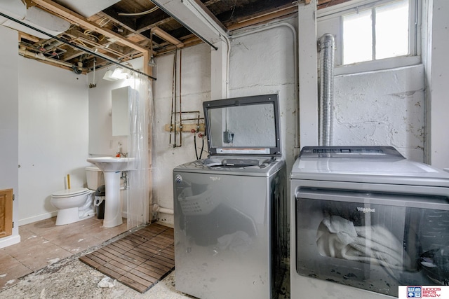 clothes washing area with separate washer and dryer and laundry area