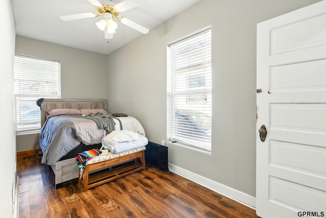 bedroom with baseboards, dark wood finished floors, and ceiling fan