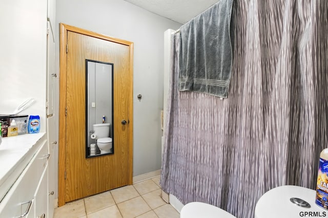 bathroom with tile patterned floors, vanity, and toilet