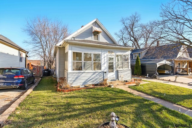 view of front of house with fence, entry steps, and a front lawn
