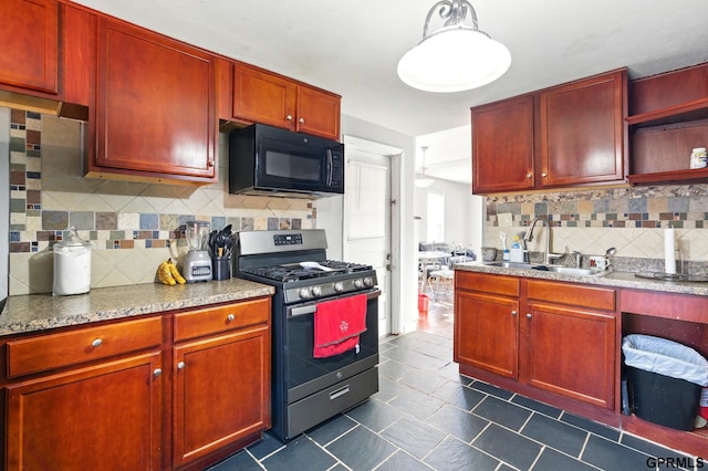 kitchen featuring decorative backsplash, black microwave, stainless steel gas range oven, dark brown cabinets, and a sink