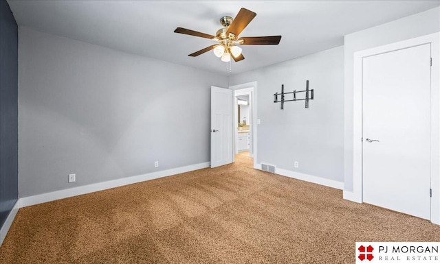 unfurnished bedroom with carpet floors, baseboards, visible vents, and ceiling fan