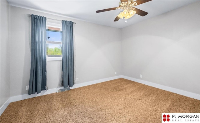 empty room with carpet floors, baseboards, and visible vents