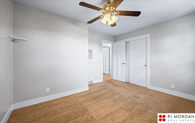 unfurnished bedroom featuring visible vents, carpet, baseboards, and a closet